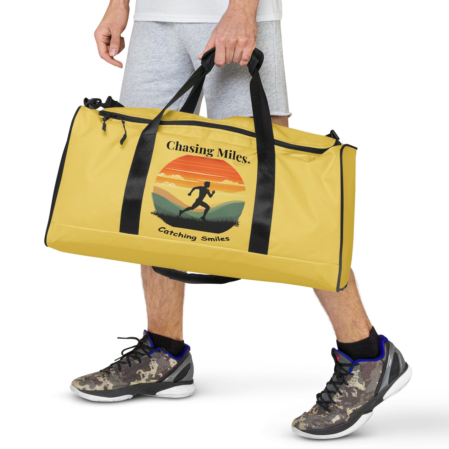 Person holding a yellow duffel bag with a graphic design on a white background