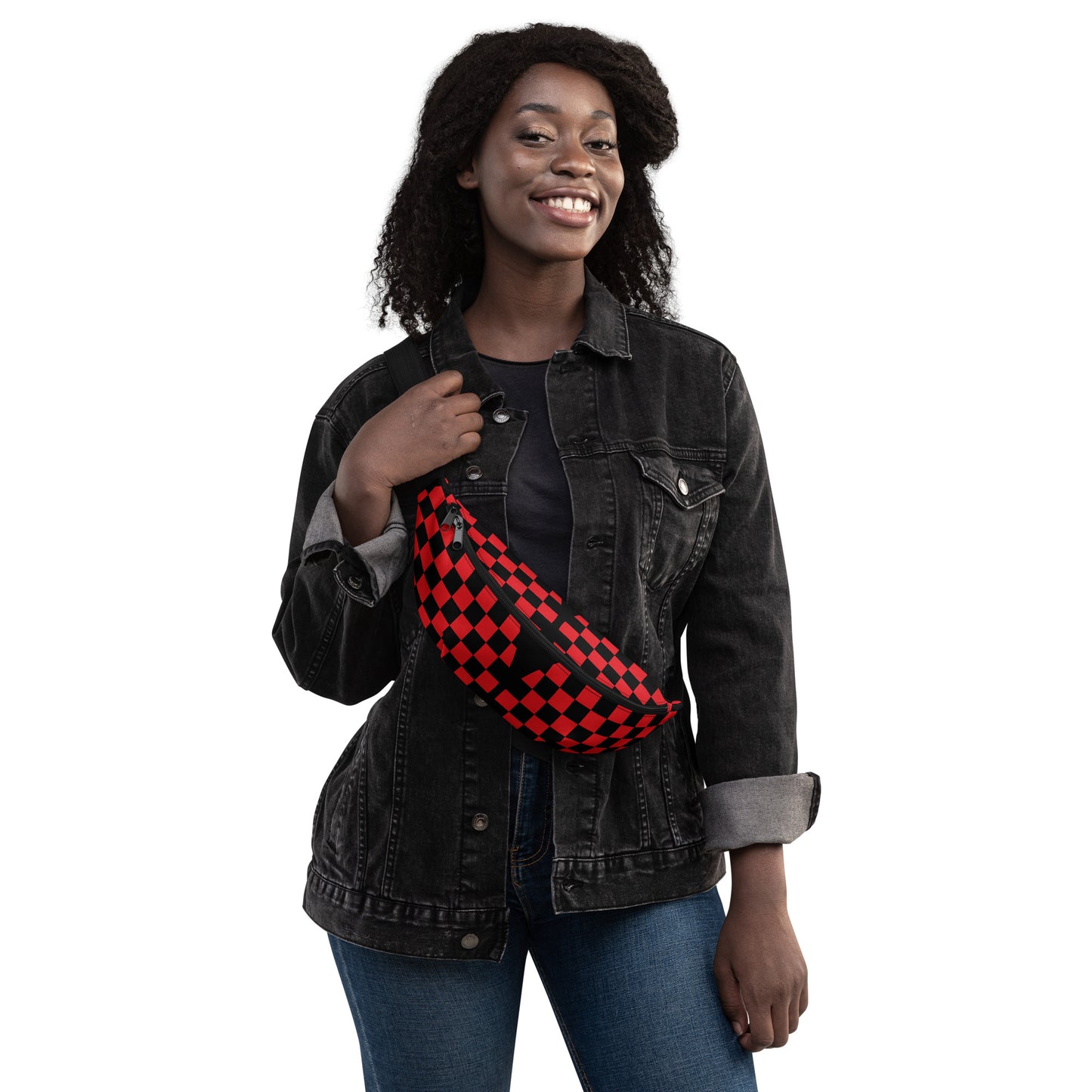Woman wearing a black denim jacket with a red and black checkered bag over her shoulder on a white background