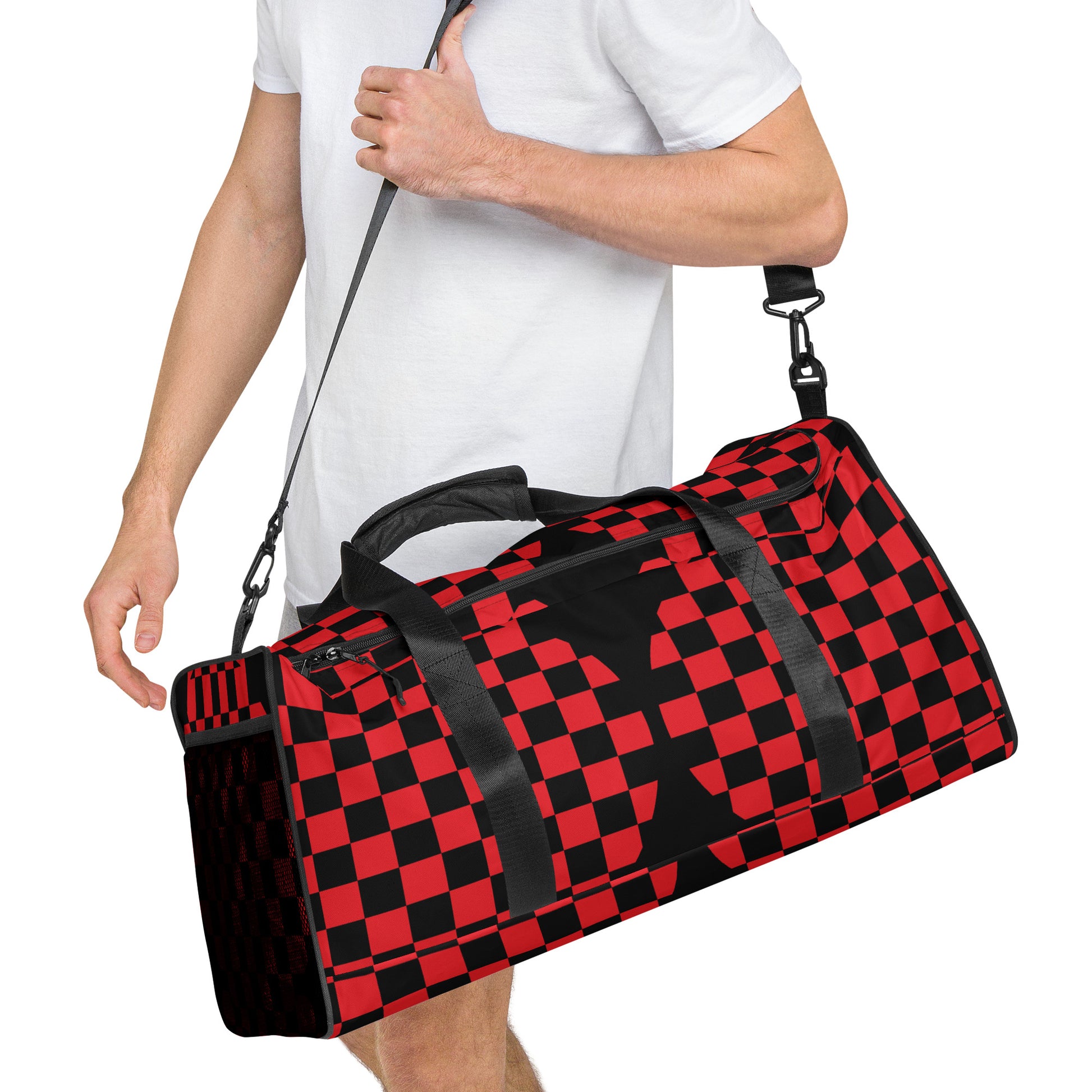 Person holding a red and black checkered duffel bag on a white background