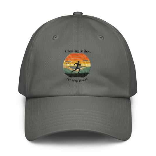 Gray cap with a sunset and silhouette design on a white background
