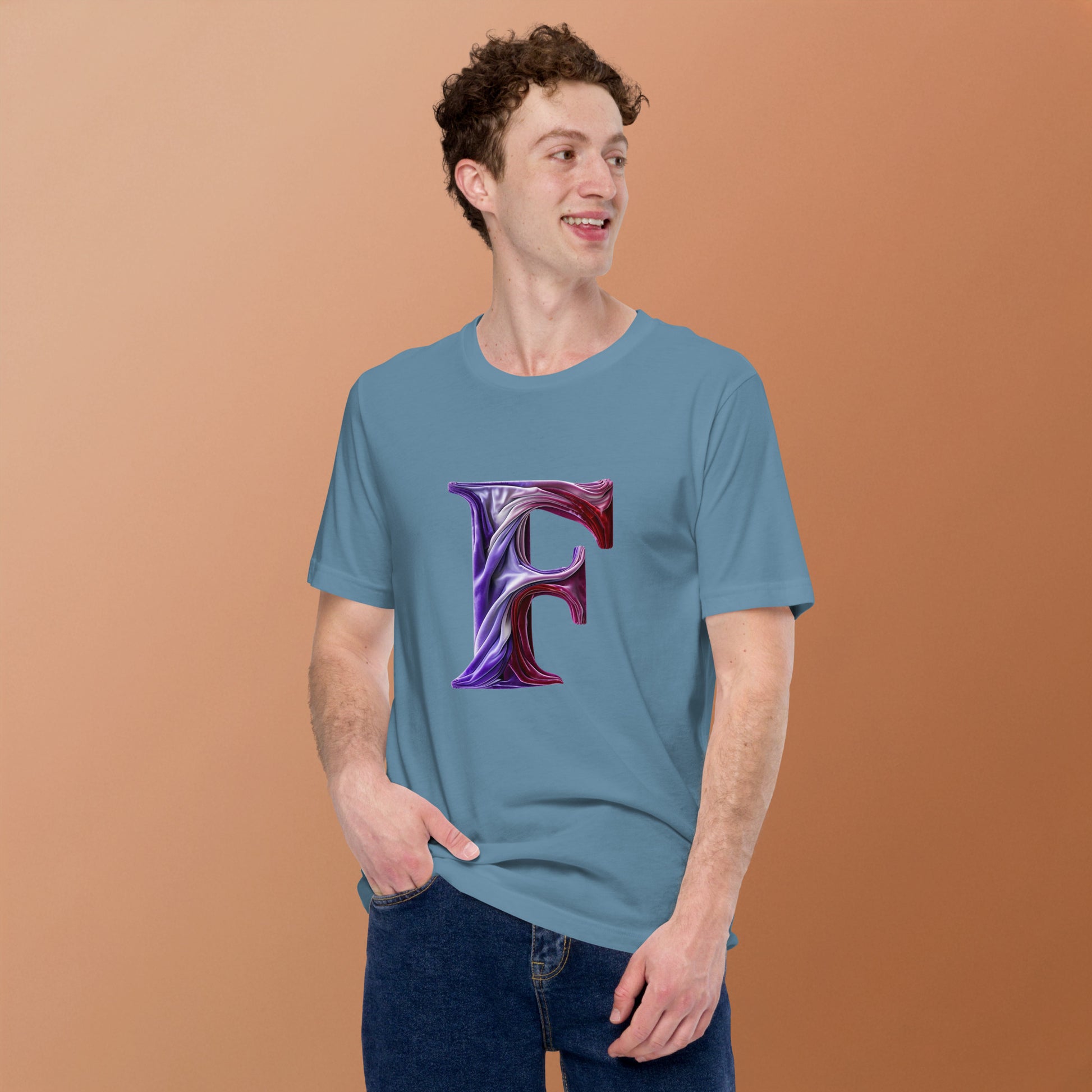 Man wearing a blue t-shirt with a purple letter 'F' design on a brown background