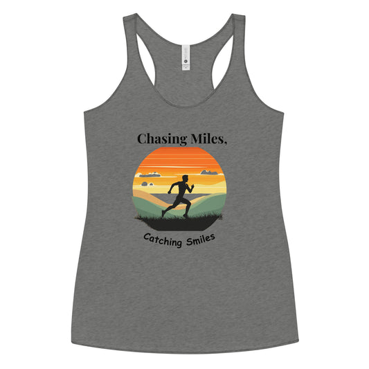 Gray tank top with a sunset design and text 'Chasing Miles, Catching Smiles' on a white background
